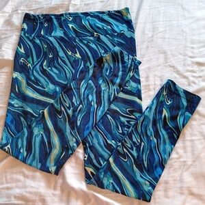 Women's multi-color high waist leggings with a sleeveless athletic shirt.